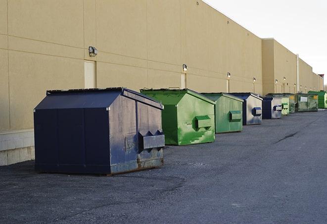 an assortment of sturdy and reliable waste containers near a construction area in Blue Springs